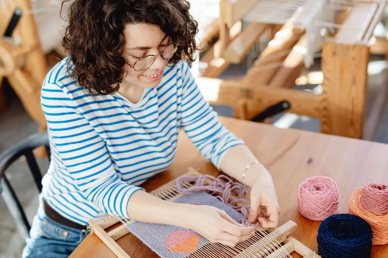 Textile artisan working with wool in a workshop